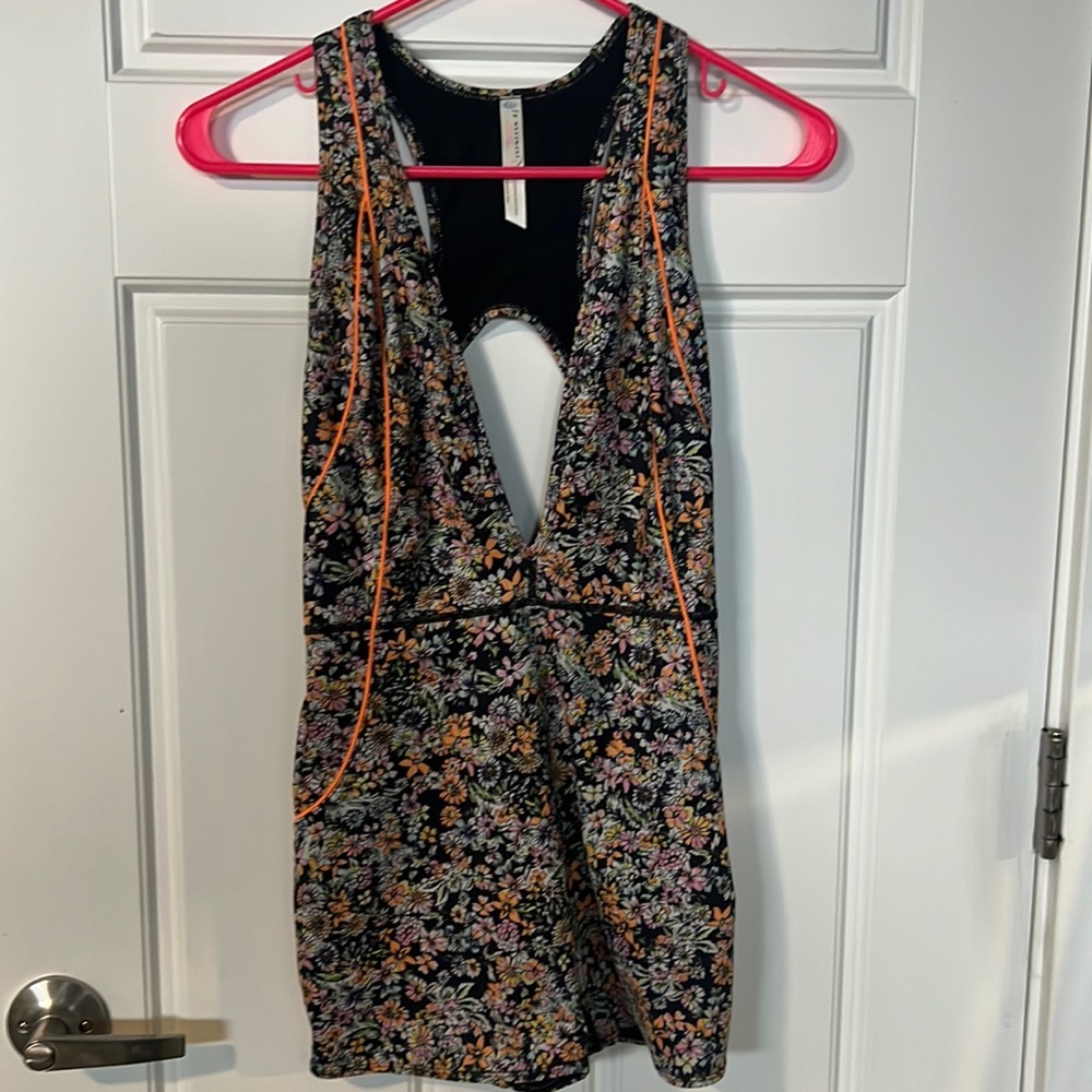 Floral print with neon orange seems. Black lining